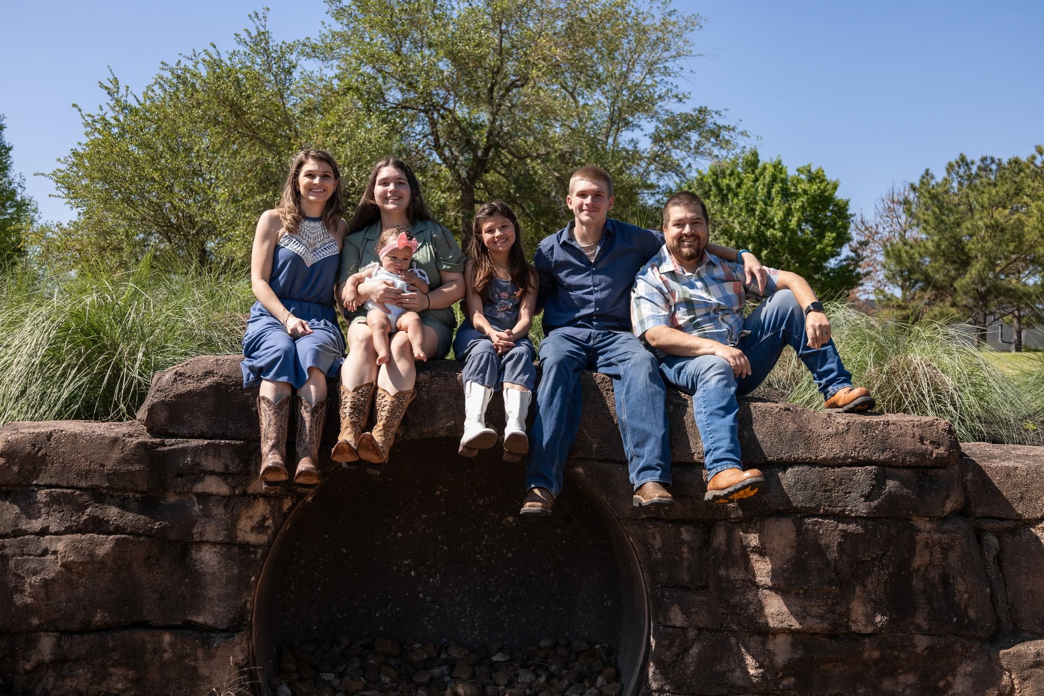Deleana's family sitting together on rocks